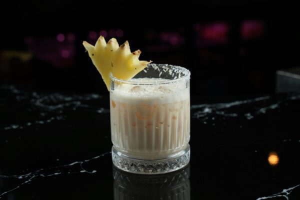 Pina Colada Cocktail Decorated with a Piece of Pineapple